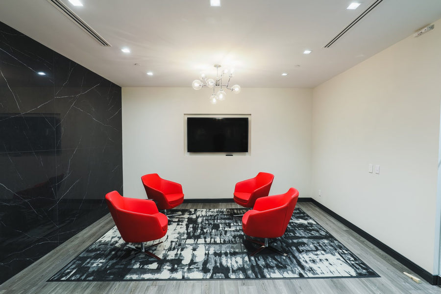 Modern room with red chairs and a black and white rug