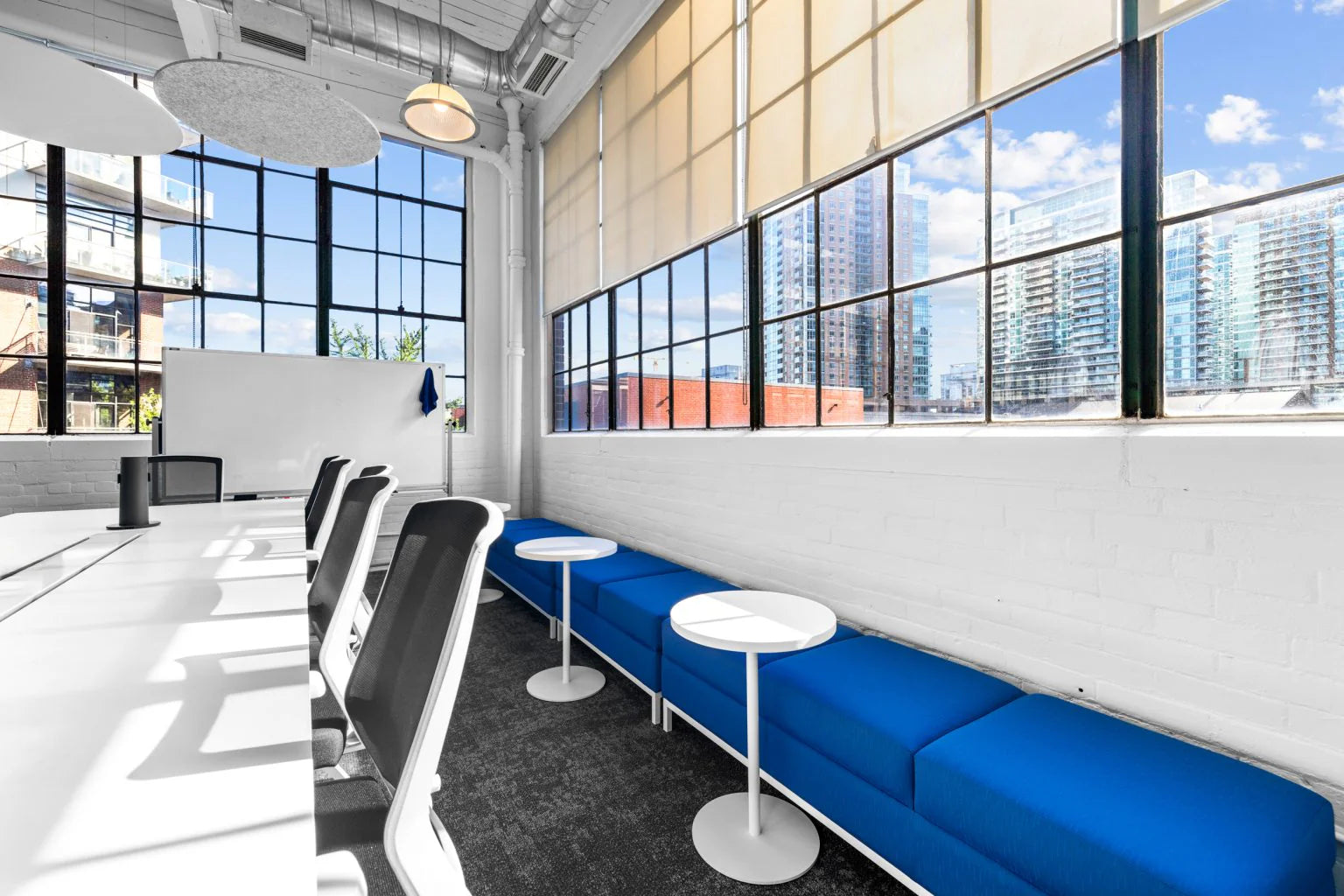 Modern office space with blue seating area and large windows