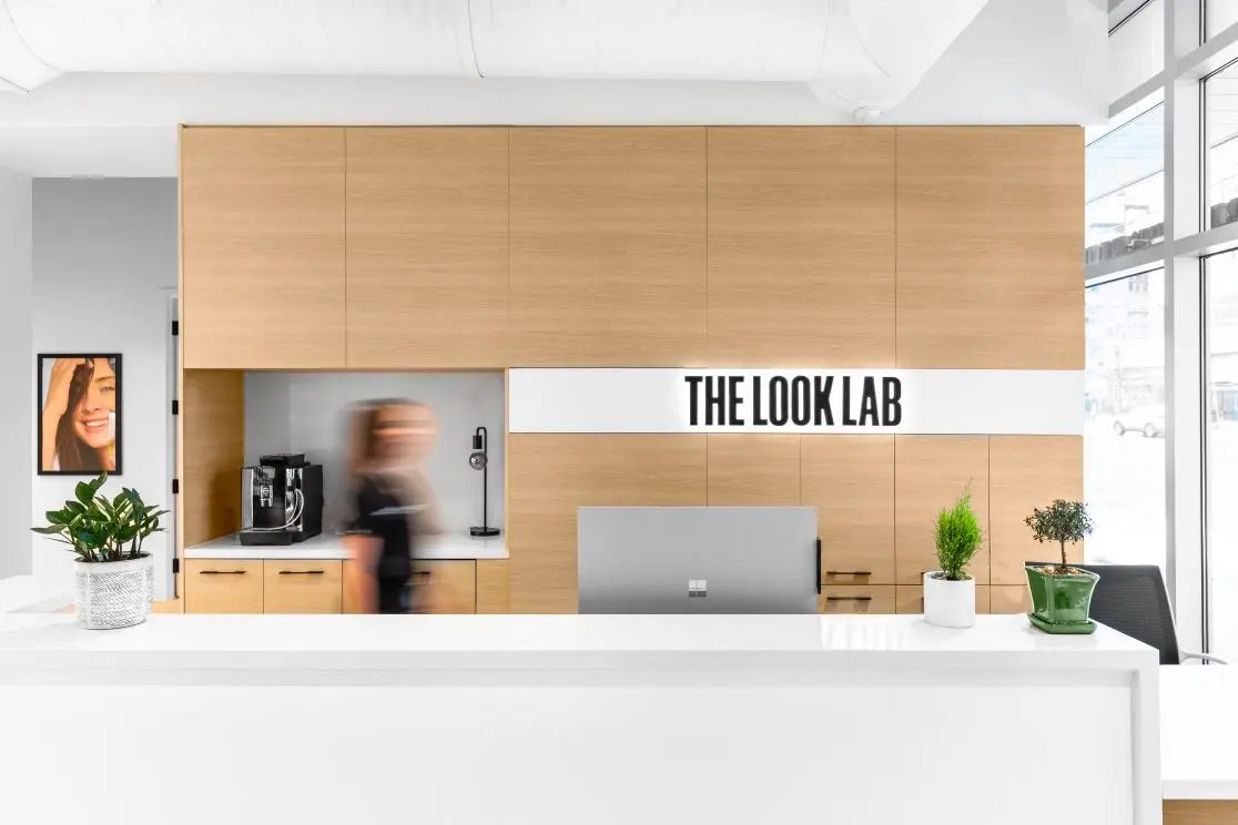 Modern office interior with a reception desk and 'The Look Lab' sign.