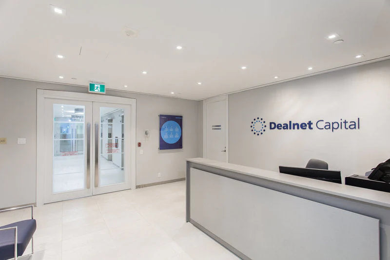 Office reception area with 'Dealnet Capital' logo on the wall.