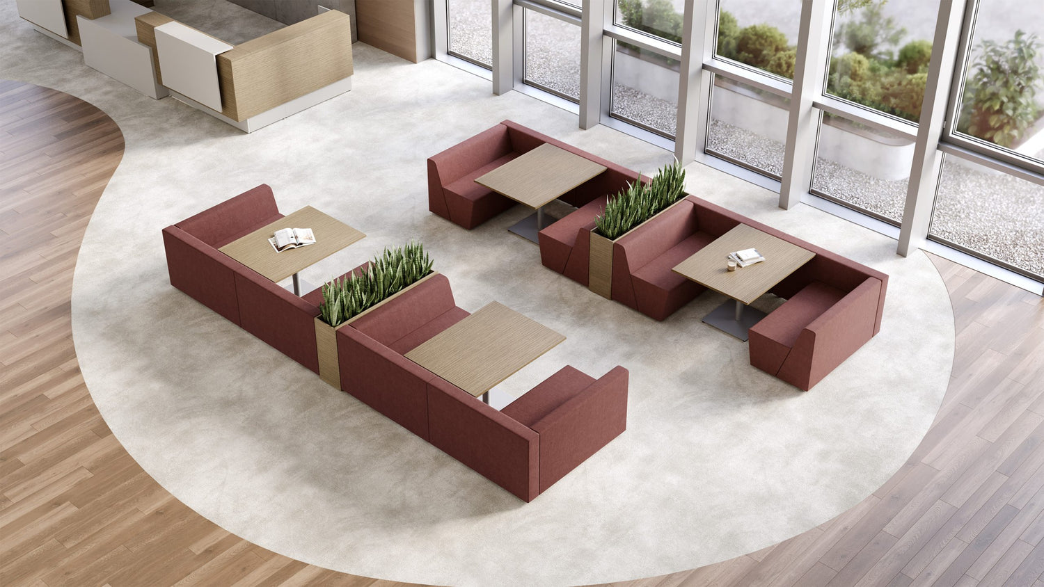 Modern office furniture with red sofas and beige tables in a well-lit room.