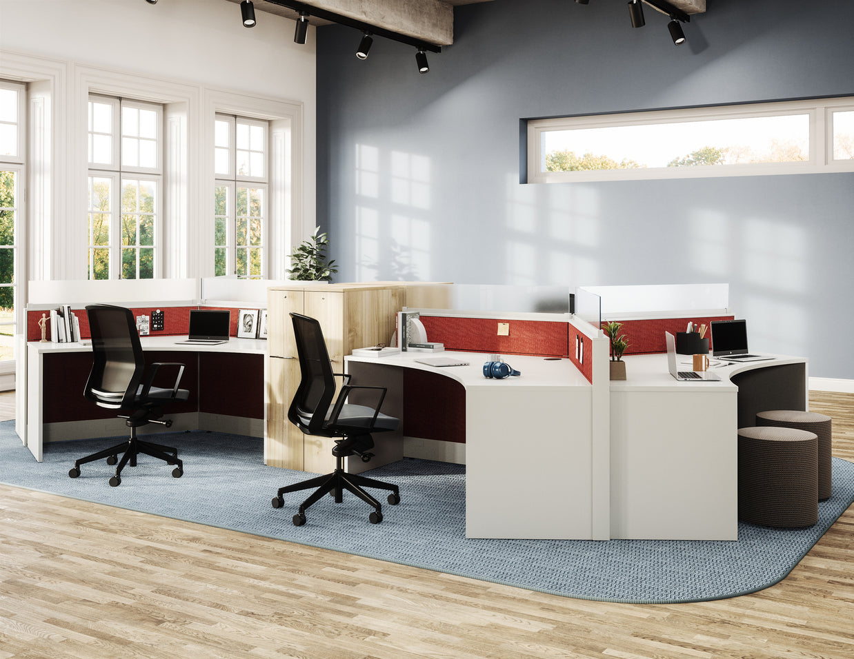 Modern office space with desks, chairs, and large windows.