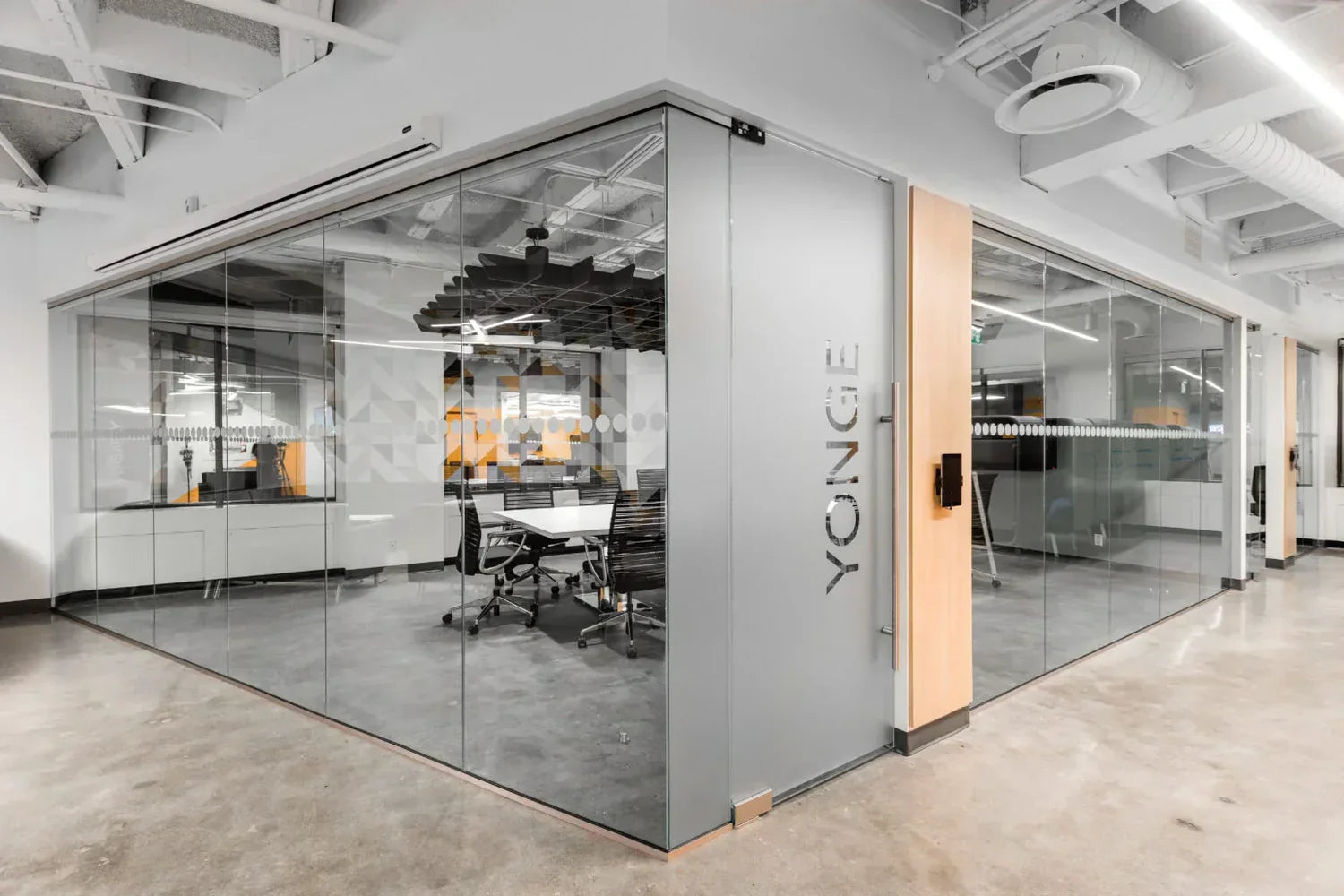 Modern office space with glass walls and 'YONGE' branding.